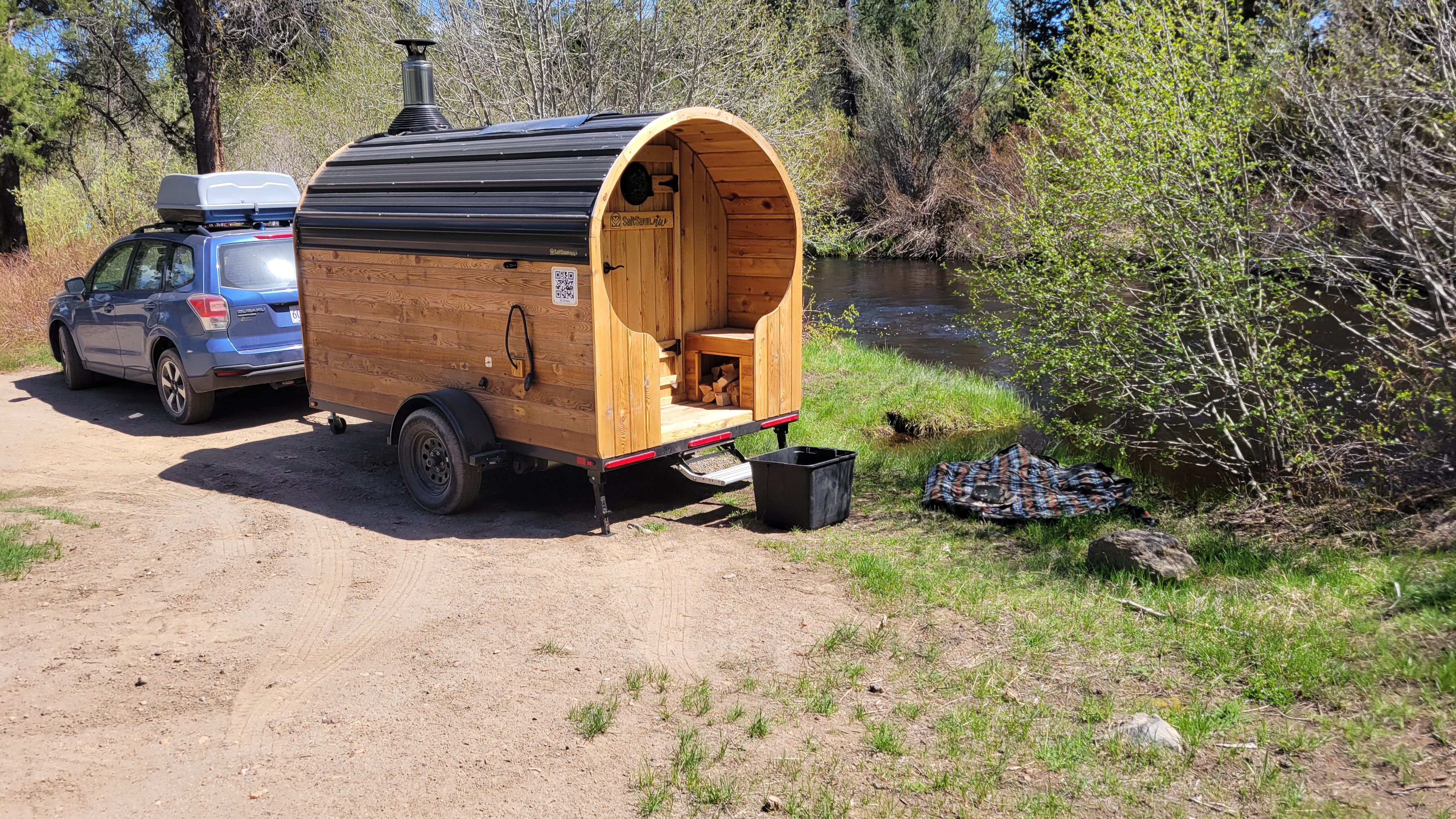 Flowing Flame mobile sauna parked by a river in Oregon